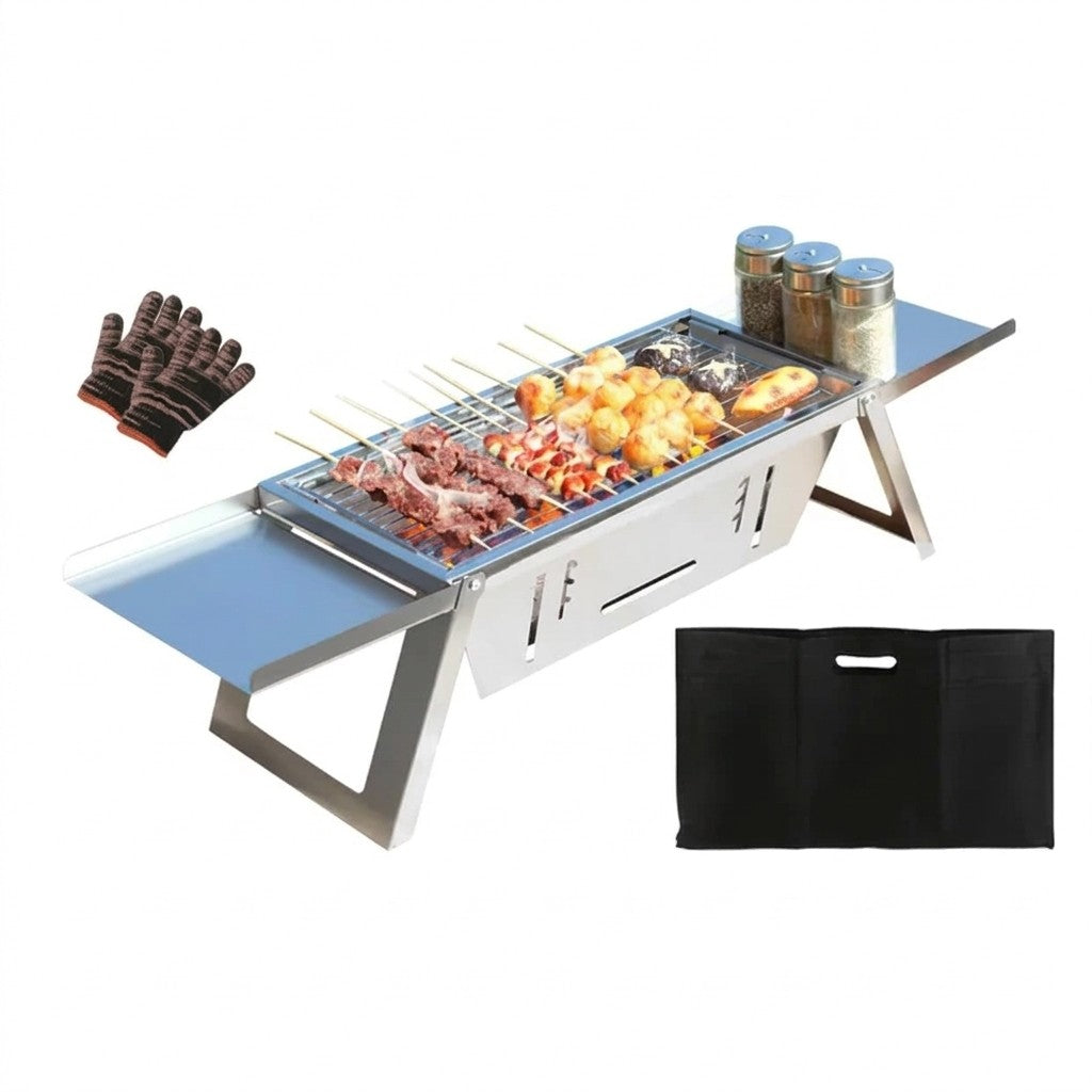 A stainless steel portable folding grill with skewers and food cooking on the grate, shown on a white background with a pair of heat-resistant gloves, spice jars, and a black carrying bag.