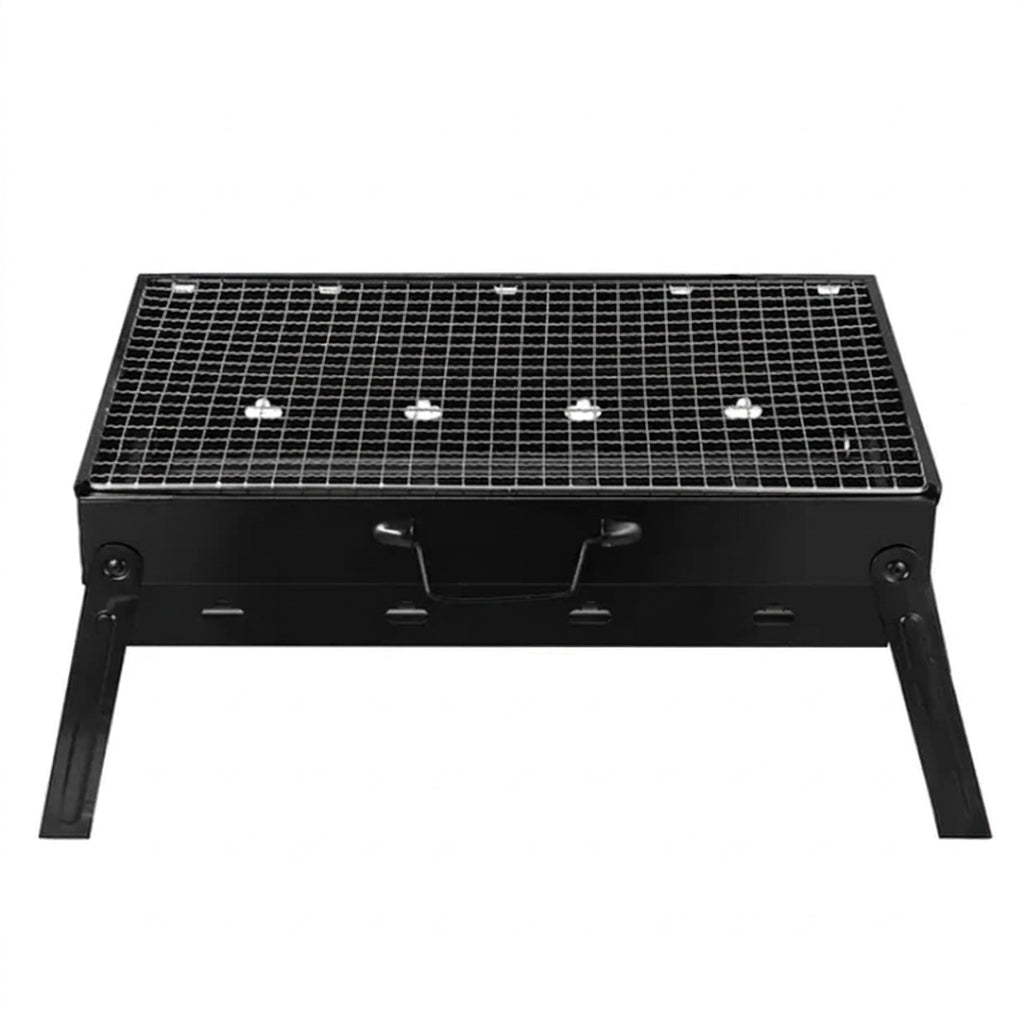 A black portable folding charcoal grill with skewers of meat, vegetables, and shrimp cooking on the grate, plus a small saucepan with a brush shown below on a white background.