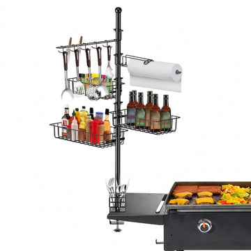 Outdoor grill setup with a metal rack holding utensils, bottles, and paper towels on a white background.