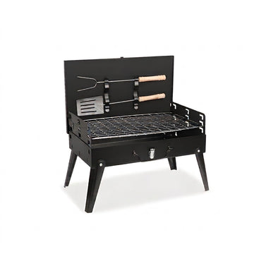 A black metal mini grill with legs, a wire grate, and a back panel holding two tools with light wood handles, shown on a white background.
